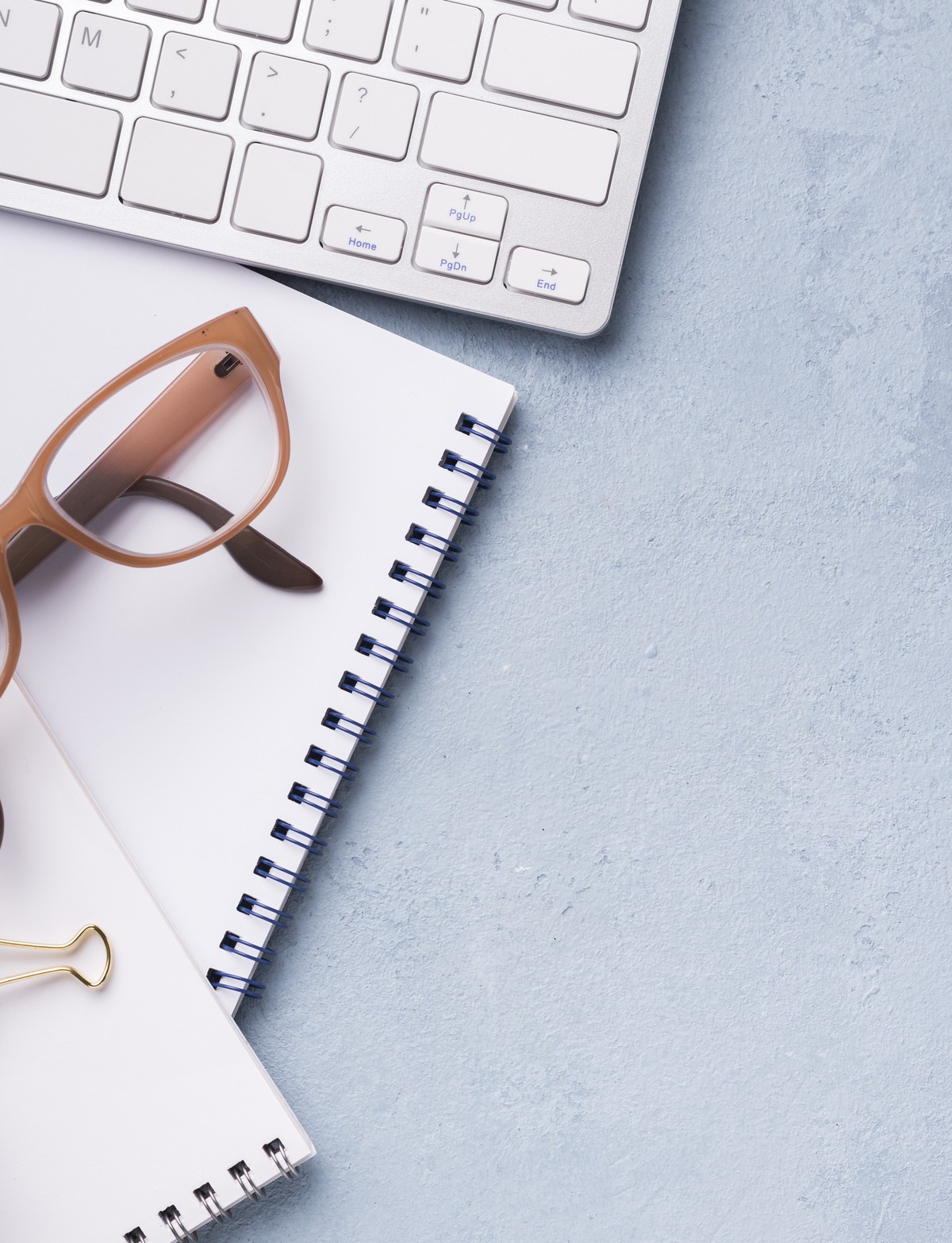 desk with glasses and notebook